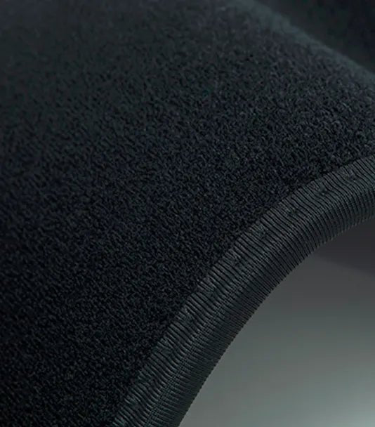 Hot Wave Massage Belt Extreme close-up of the black fabric texture and ribbed edge stitching of a massage belt.