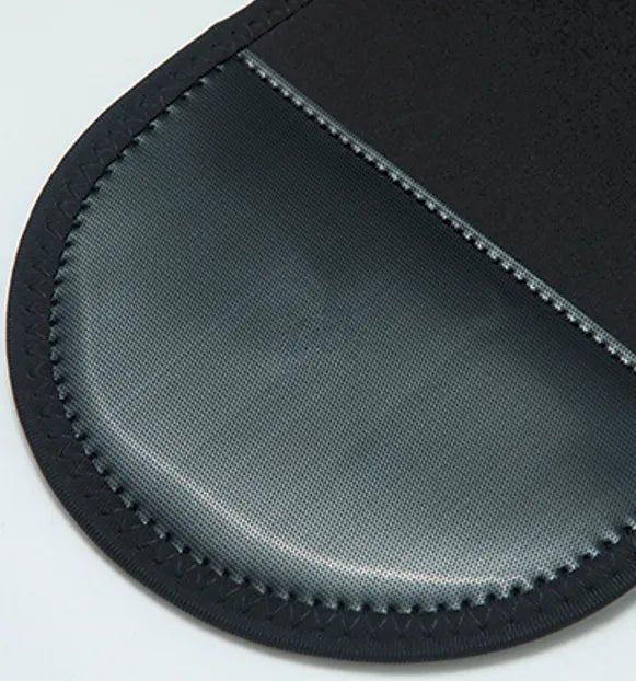 Hot Wave Massage Belt Macro shot of the rounded end of a black belt showing smooth grey and black materials.