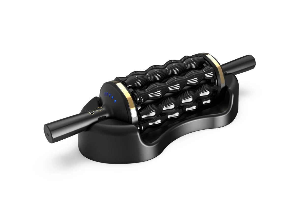 Rolling Percussive Massager Black rolling percussive massager with gold accents resting on a matching black charging base.