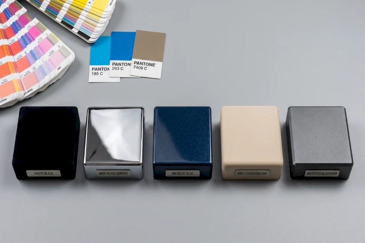 ODM_-_square_device_component_samples_showing_matte_black_high_gloss_chrome_and_metallic_blue_surface_finishes_with_pantone_cards-Pages-Ecozy
