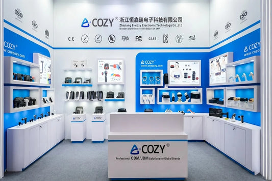 Our_Story_-_canton_fair_optimized_modern_trade_show_exhibition_booth_displaying_various_smart_massagers_and_international_compliance_certificates-Pages-Ecozy
