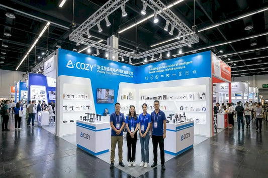 Our_Story_-_proud_company_sales_team_standing_in_front_of_the_international_exhibition_booth_at_global_sources_trade_show-Pages-Ecozy