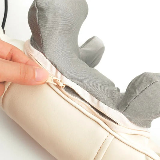 Neck and Shoulder Massager Close-up of a hand unzipping the removable fabric cover of a neck and shoulder massager.
