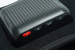 Hot Wave Massage Belt Close-up of a black control unit with a red power button and function icons on a belt.