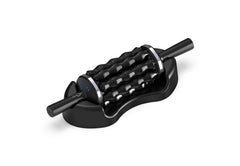 Rolling Percussive Massager Black rolling percussive massager resting in its charging dock, showing blue indicator lights on the handle.